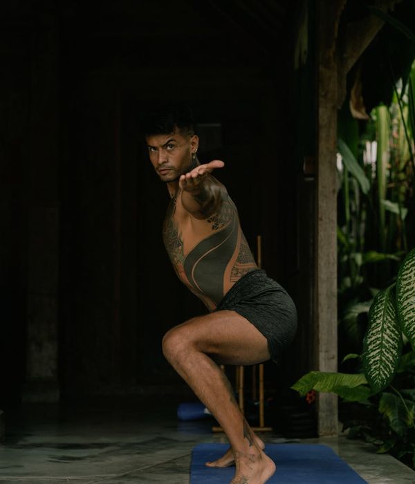 Athlete in a warrior yoga pose, showing strength and balance.